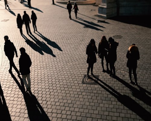 People walking at a comfortable pace during evening in a city